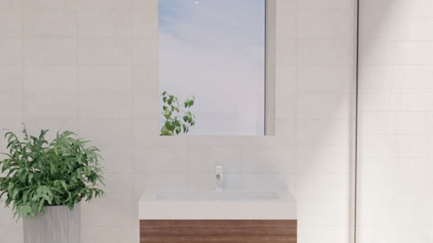 Bathroom with mirror along with wash basin, plant and white wall tiles.