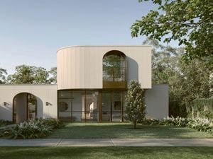 Modern house with curved facade, arched windows, lush garden and lawn.