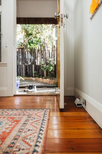 A smart mouse trap behind a door. The white shell matches with the decor of the house