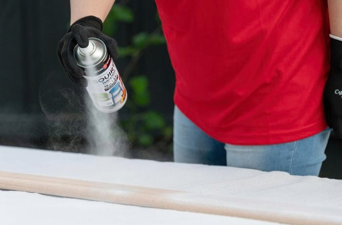 spray painting timber in white paint