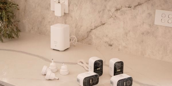 Four security cameras on top of a countertop.