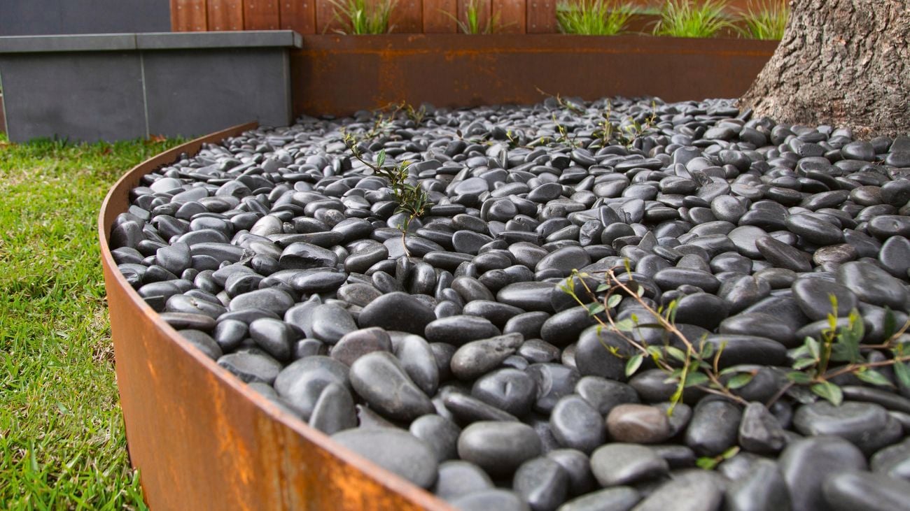 Black pebbles in a Tuscan Path weathered steel container