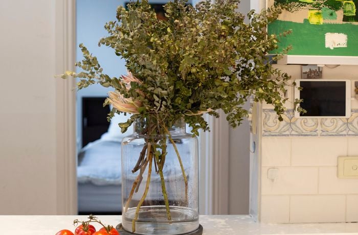 Kitchen bench with vase and dried flowers.