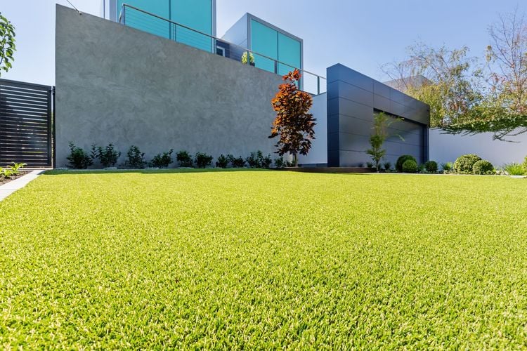 A Tuff Turf lawn in front of a functionalist building