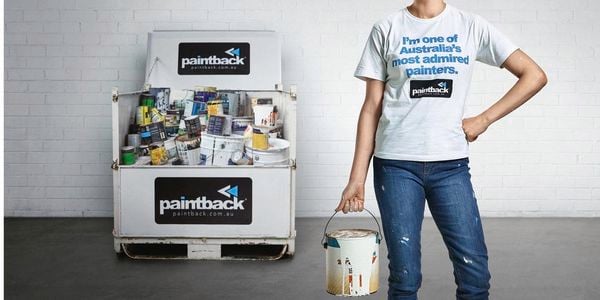 woman holding empty paint can