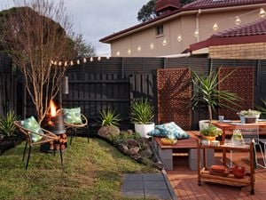 Outdoor entertaining area with outdoor furniture and festoon lights.
