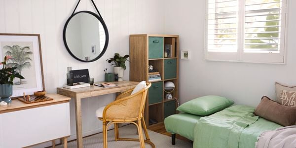 Bedroom with study space under a hanging mirror 