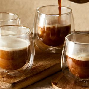 four glass cups filled with coffee