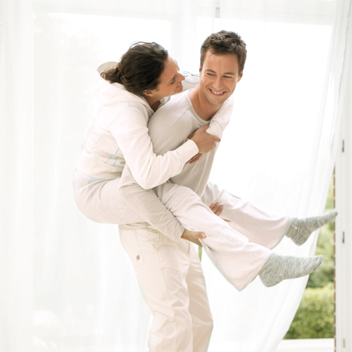 A man piggy backing a lady