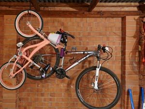 A bike hanging in a garage.