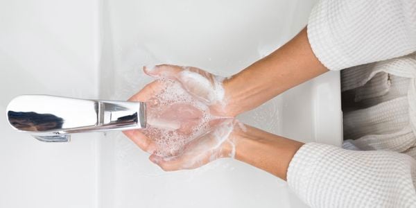 A person washing their hands.