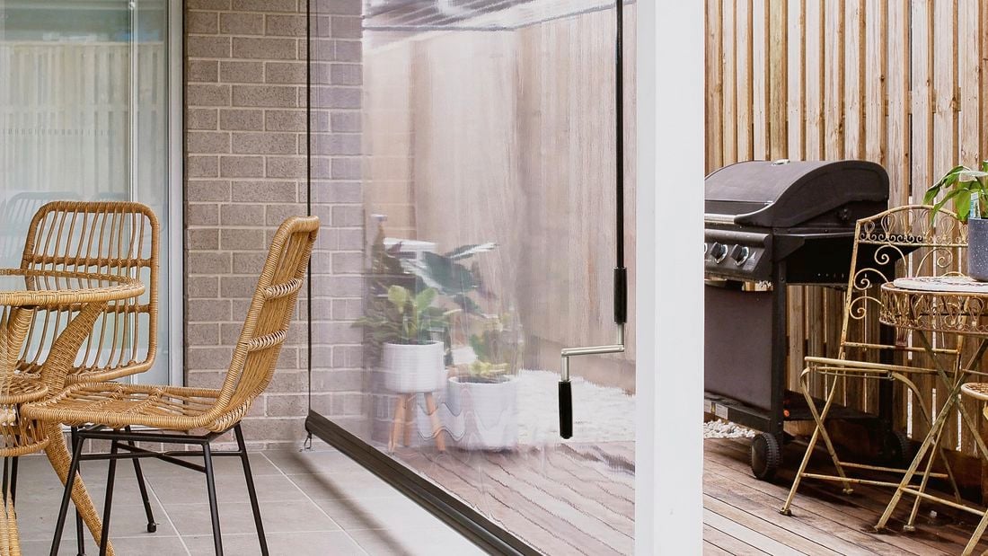 An outdoor patio area set up with blind pull down 