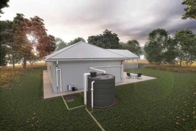 The backyard of a house attached by downpipe to a water tank surrounded by trees.