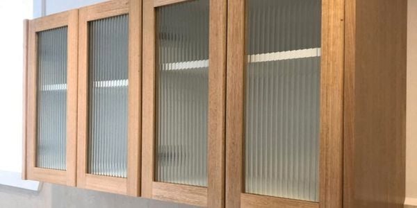 A laundry with a timber overhead cabinet