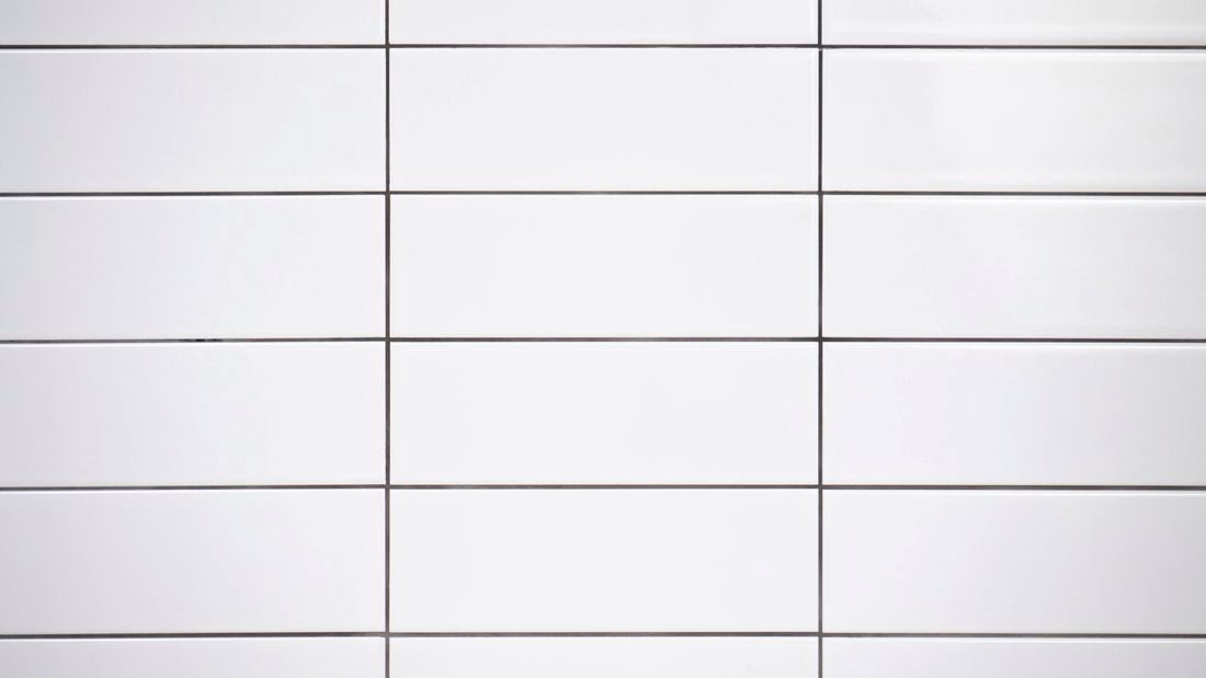 Freshly grouted white tiles 