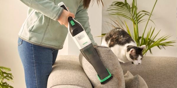 hand vac being used to clean