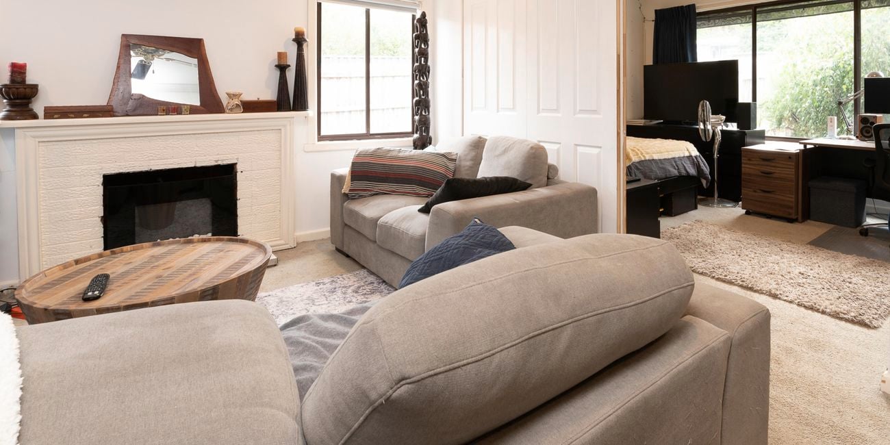 Living room with sliding doors into bedroom.