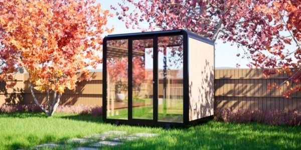A pod outside amongst trees and a fence outside.