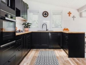 Kitchen with black and timber theme.