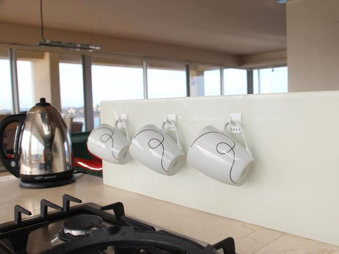 coffee mugs hanging on a kitchen wall
