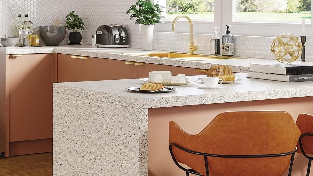 Pink kitchen with white honeycomb tiles and granite benchtop