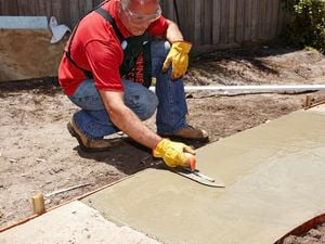A Bunnings team member restoring a concrete path