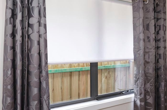 A window with curtains and a blind
