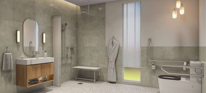 Modern accessible bathroom featuring a walk-in shower with a privacy curtain, handheld showerhead, grab rails, shower bench, wall-mounted vanity with mirror, and an accessible toilet with support rails. The space combines soft grey tiles, warm timber finishes and contemporary lighting.