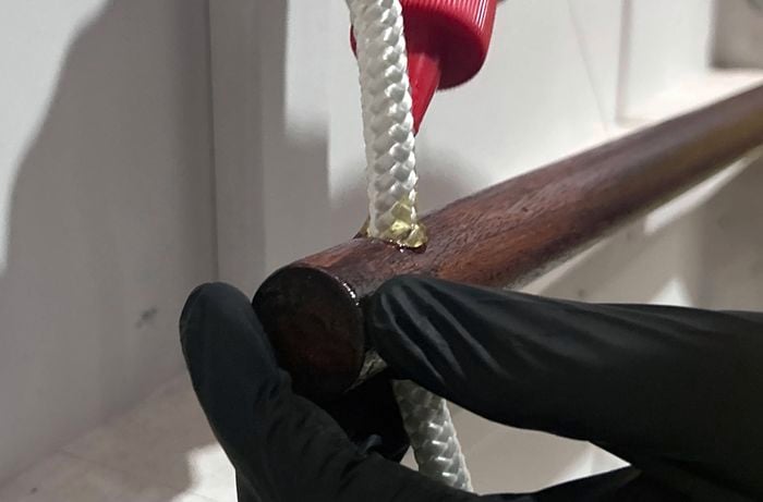 Adhesive being applied to a hanging towel rail
