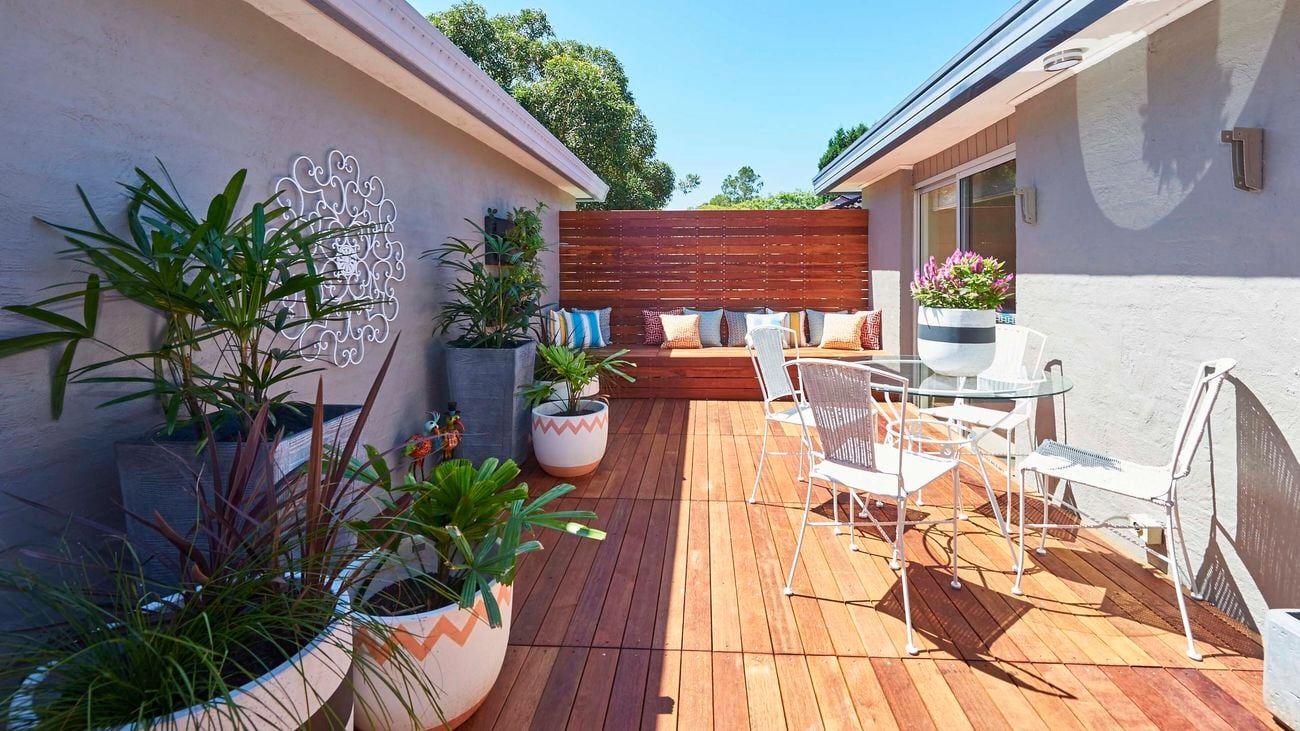 Outdoor entertaining area featuring timber deck, seating furniture and plants.