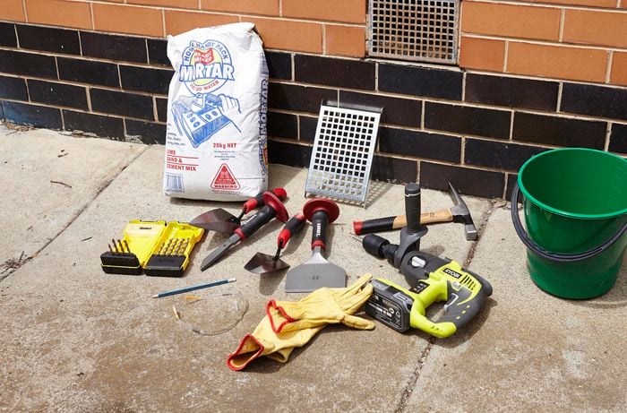 All of the tools and materials you need to replace a vent in a brick wall