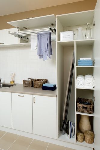 A variety of shelving and storage solutions for a laundry space