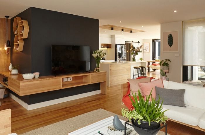An open plan living room with television, lounge and coffee table