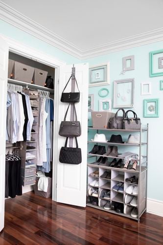 Wardrobe containing closet organisers and clothes, and a free-standing organiser