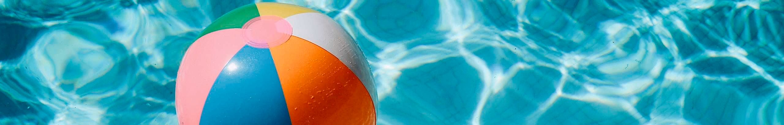 Beach ball in swimming pool.