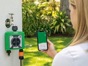 Customer operating the Holman tape timer on their phone using the App