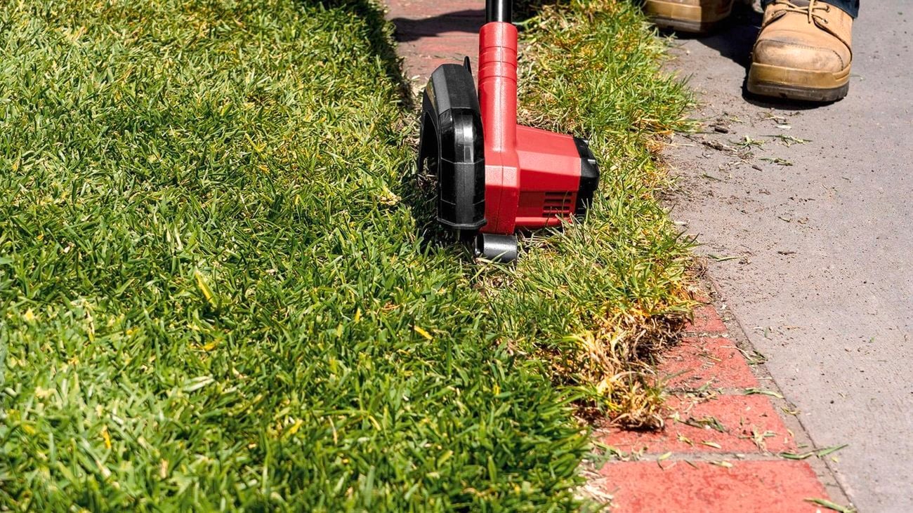 a person using a mower in the lawn