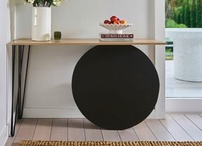  A hallway table storage solution near an entryway to a home.