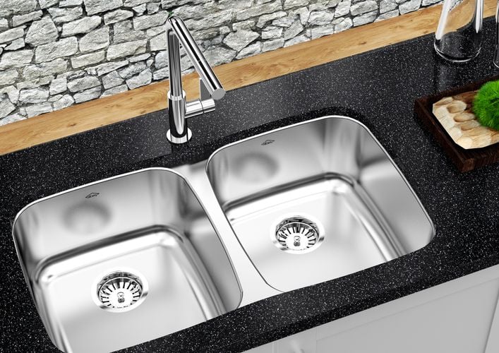 Kitchen benchtop with stainless steel double sink and tapware