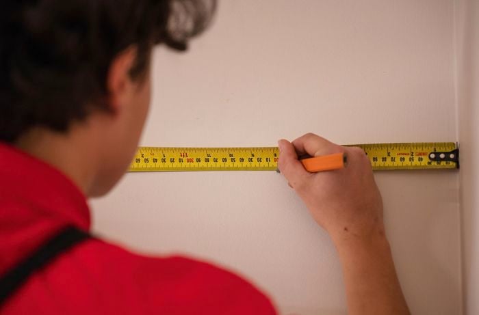 Bunnings TM marking on the wall with ruler pencil