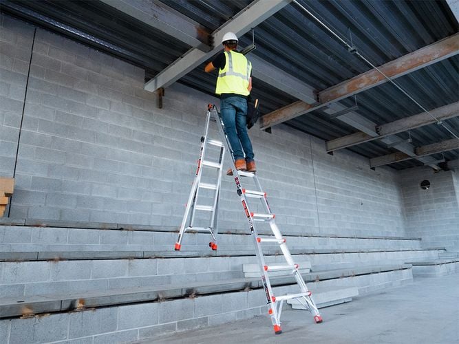 Person working on adjustable, extendable ladder