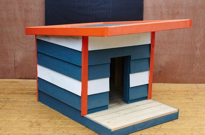 Finished DIY dog kennel in blue, orange and white colours.
