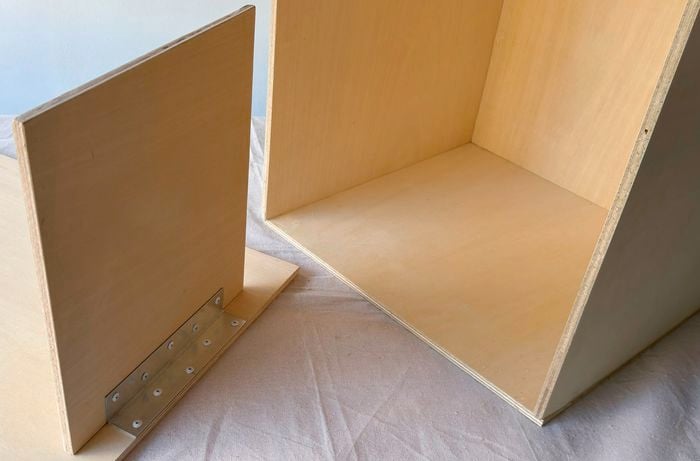 A metal bracket reinforcing a timber joint.]  