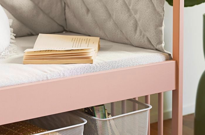 Finished kids cot, painted pink with open book on seat