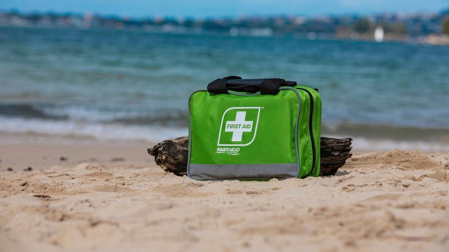 FastAid Family Green Soft Pack First Aid Kit on the beach
