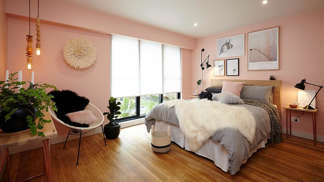 Bedroom with a double bed, chair and rug.