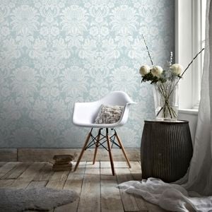 Chair with flowers in a vase in a room