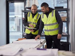 Bunnings trade team members looking at plans.