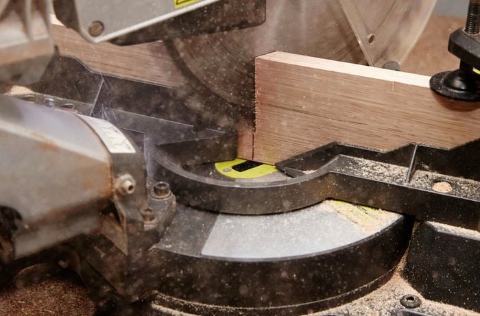 Close-up of cutting timber with a drop saw