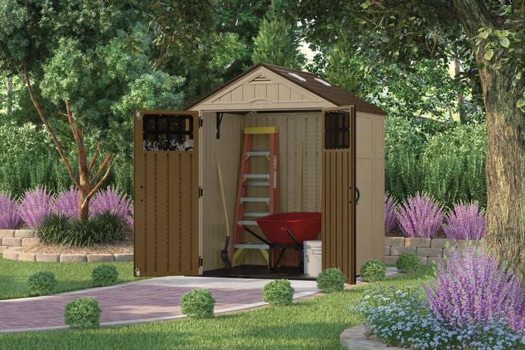 Backyard with a garden shed containing a wheelbarrow, ladder and garden tools